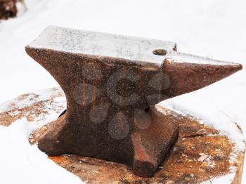 anvil in old abandoned village smithy in winter