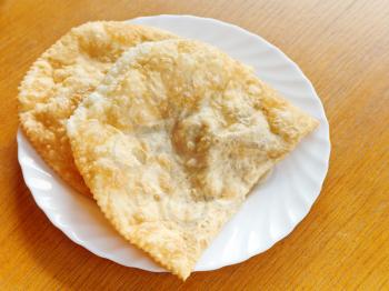 Crimean tatar cuisine - cheburek pie on white plate