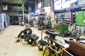 turnery workshop with lathes and details of disassembled engine