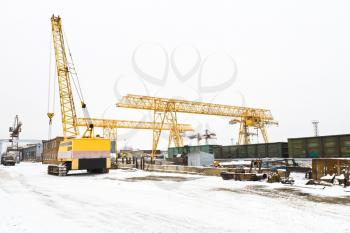 industrial view with different cranes in open storage area