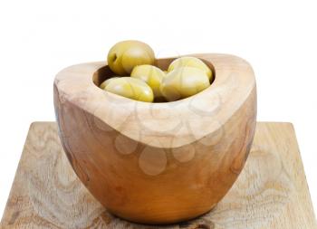 green olives in wooden bowl on board isolated on white background