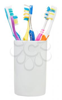 five toothbrushes and interdental brush in ceramic glass - family set of toothbrushes isolated on white background