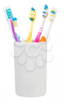 five toothbrushes in ceramic glass - family set of toothbrushes isolated on white background