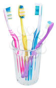 four tooth brushes in glass - family set of toothbrushes isolated on white background