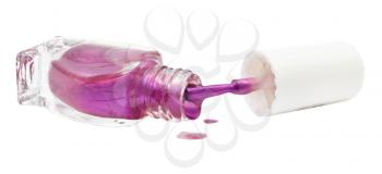 bottle and spilled purple nail polish isolated on white background
