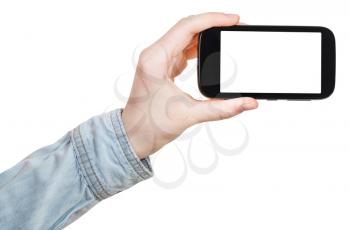 hand in shirt holds smartphone with cut out screen isolated on white background