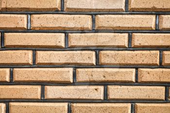 background from yellow brick wall with masonry joints