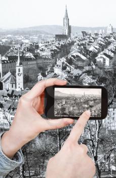 travel concept - tourist taking photo of Bern city on mobile gadget, Switzerland