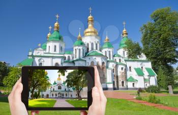 travel concept - tourist taking photo of Saint Sophia Cathedral in Kiev on mobile gadget, Ukraine