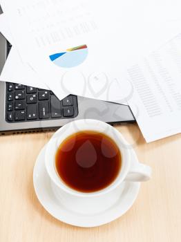 business workflow - above view cup of tea and office tools on table