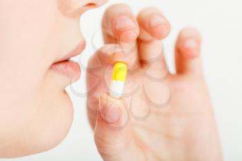 woman takes pilule close up