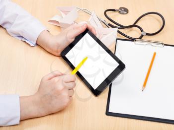 doctor works with tablet pc with cut out screen