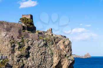 view of Norman castle in Aci Castello town and Cyclopean Rocks (Islands of the Cyclops), Sicily, Italy