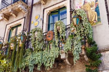 TAORMINA, ITALY - APRIL 3, 2015: traditional decoration on balcony of urban house in Taormina town, Sicily.