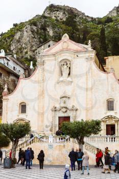 TAORMINA, ITALY - APRIL 3, 2015: people on Piazza IX Aprile near Chiesa di san Giuseppe, Taormina, Sicily. The church was built between late 1600 and early 1700.