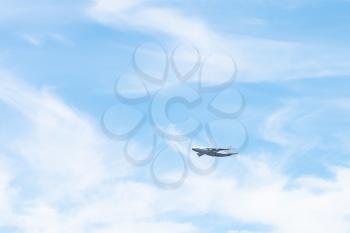 transport aircraft in white clouds in blue sky