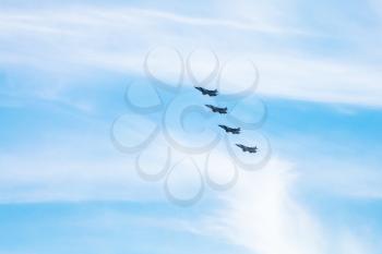 four military fighter aircrafts in cloudy blue sky