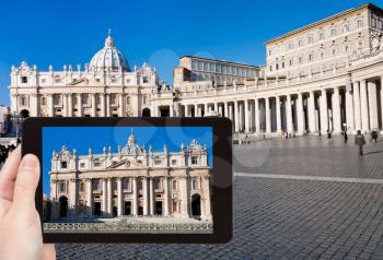travel concept - tourist takes photo of St.Peter Cathedral on square in Vatican, Rome, Italy on tablet pc