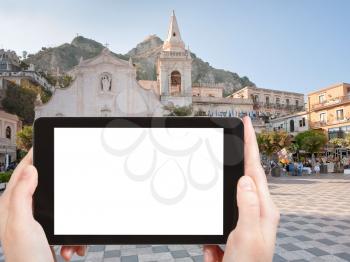 travel concept - tourist photograph Piazza IX Aprile near Chiesa di san Giuseppe, in Taormina, Sicily, Italy on tablet pc with cut out screen with blank place for advertising logo