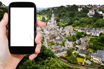 travel concept - tourist photograph above view of town Dinan and river Rance, France on smartphone with cut out screen with blank place for advertising logo