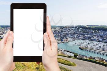 travel concept - tourist photograph Etretat town on English Channel coast in Normandy, France on tablet pc with cut out screen with blank place for advertising logo