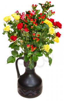 yellow, red roses and hypericum flowers in ceramic jug on white background
