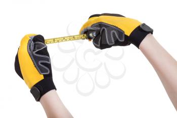 builder hands in safety glowes with measuring tape isolated on white background