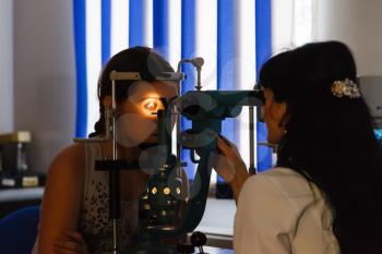 vision screening of girl in ophthalmologist office
