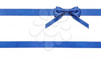 one blue satin bow in upper right corner and two horizontal ribbons isolated on horizontal white background