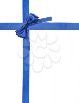 turned blue satin bow in upper right corner and two intersecting ribbons isolated on vertical white background