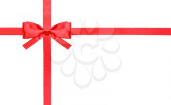 one red satin bow in upper left corner and two intersecting ribbons isolated on horizontal white background