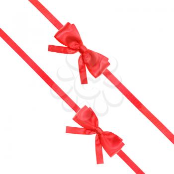 two red satin bows and two diagonal ribbons isolated on square white background