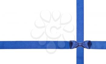 one blue satin bow knot in lower right corner and two intersecting ribbons isolated on horizontal white background