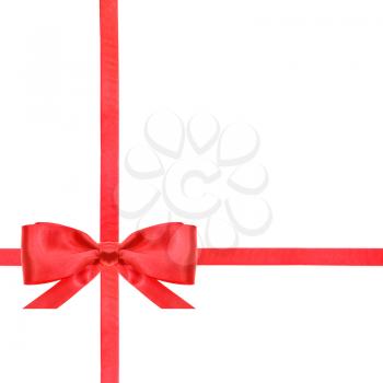 one red satin bow in lower left corner and two intersecting ribbons isolated on square white background