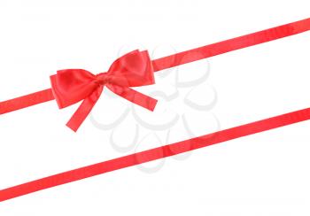 big red satin bow and two diagonal ribbons isolated on horizontal white background