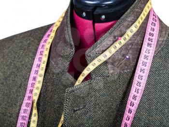 tailoring of collar for tweed jacket on mannequin isolated on white background