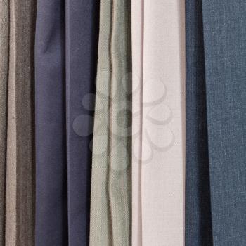row of various woolen trousers in tailoring atelier close up