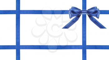 one blue satin bow in upper right corner and four intersecting ribbons isolated on horizontal white background