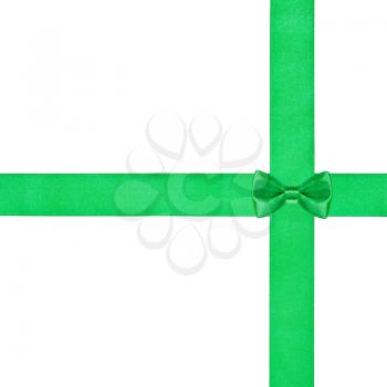 one little green bow knot on two crossing satin ribbons isolated on white background