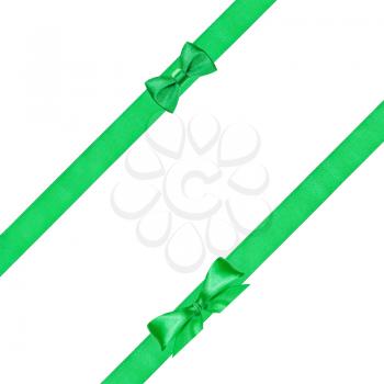 two green bow knots on two diagonal satin ribbons isolated on white background