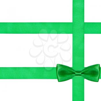 one big green bow knot on three silk ribbons isolated on white background