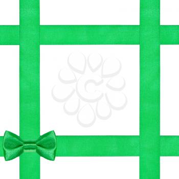 green bow knot on four satin ribbons isolated on white background