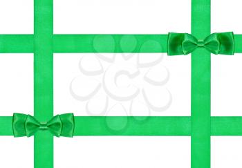 two little double green bow knots on four silk ribbons isolated on white background
