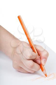 hand draws by orange pencil on sheet of paper isolated on white background