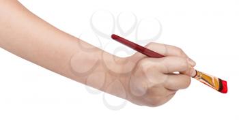 hand with artistic flat paintbrush paints in red isolated on white background