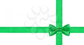 one green bow knot on two crossing satin strips isolated on white background