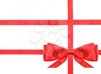 one red satin bow in lower right corner and three intersecting ribbons isolated on horizontal white background
