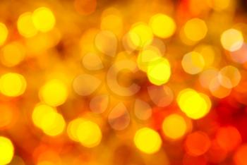 abstract blurred background - yellow and red flickering Christmas lights bokeh of electric garlands on Xmas tree