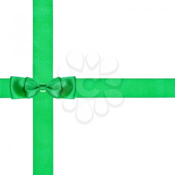 double green bow knot on two crossing satin ribbons isolated on white background