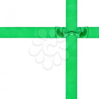 double green bow knot on two crossing silk strips isolated on white background